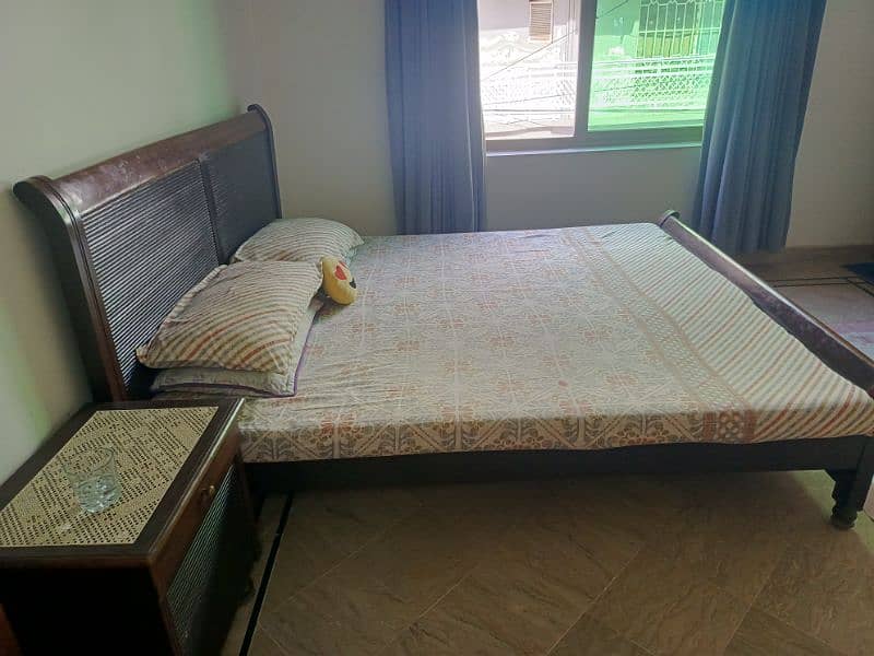 Wooden bed with 2 side tables and a mattress 1