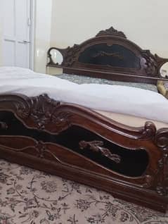 wooden bed  with tow side table and dressing table