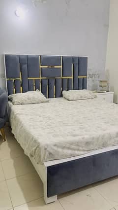 bed set with two sofa chairs along small table