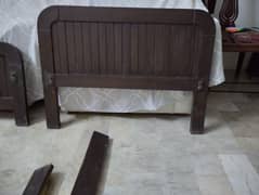 Single wooden bed without mattress