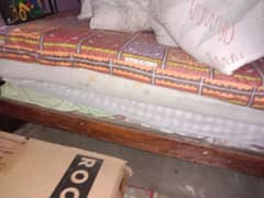 single wood bed with hard mattress