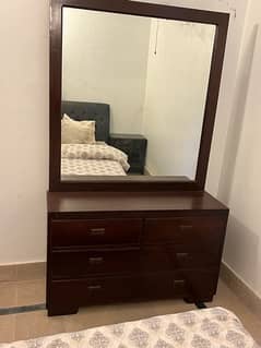 two single beds with two side tables and dressing table
