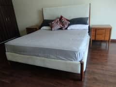 King Size, Custom Wooden bed with cloth finishing. designed by Sara F.