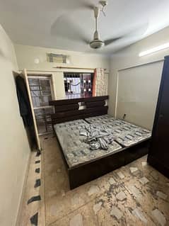 Two single wooden beds with mattress