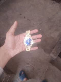 Golden watch with date