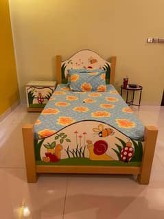 Kids handpainted single bed frame with storage cabinets and light.