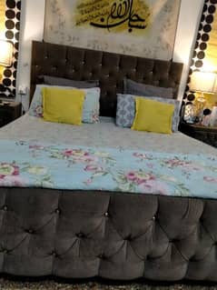 tuffed bed with side tables