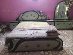 double bed with table chair and dressing