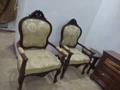 beautiful pair of chairs with glass table