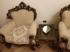 sofa set with carving on them