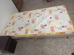 Single bed with mattress and side table