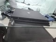 ps4 pro with two controllers and 7 games