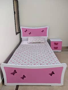 single bed with mattress and a side table
