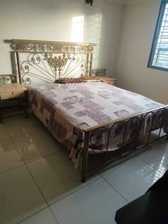 iron bed with side tables and dressing