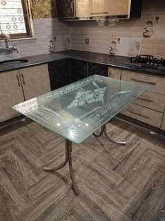 glass dining table with iron chairs
