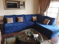 Navy Blue L-shaped Sofa with a Beige Ottoman