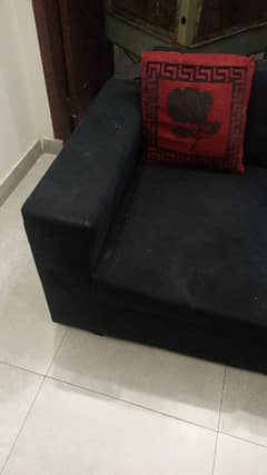 Right hand corner sofa 6 seater with 11 red and black cushions