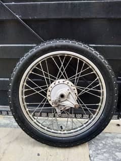 Honda 125 complete back wheel in good condition