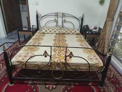 iron double bed with side table