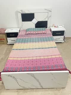 single bed with mattress and sidetables