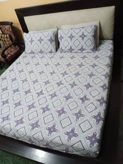 A queen size low profile wooden double bed set with mattress