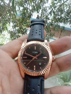 original Tomi watch black and rose gold combination.