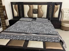 bed with side table curtans and dressing