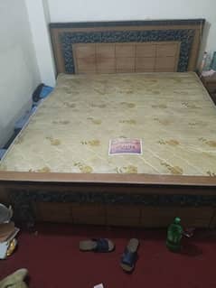 wooden bed with dressing table and side tables