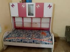 single bed with books and toy racks with molty foam mattress