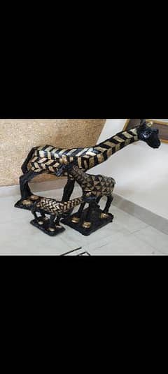 cement sculpture of golden and black giraaffe outdoor items