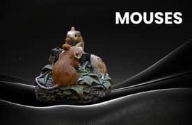 A decoration pice for room. Three mouse siting on the leaves and grass