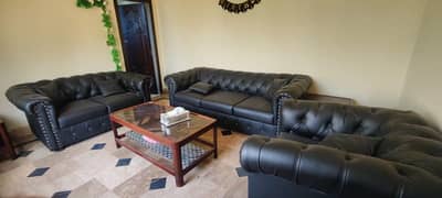 black leather sofa with 3 tables