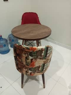 2 comfortable chairs with round table.