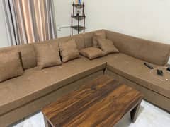 L shape sofa and 2 single sofa set is up for sale with table.