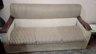 Three seater sofa for sale with cover.