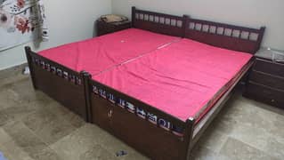 two wooden single beds with side table for adults 0