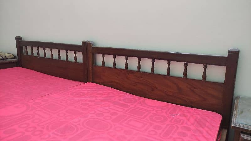two wooden single beds with side table for adults 1