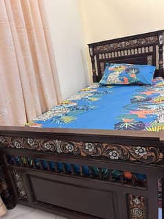 single wooden bed with mattress