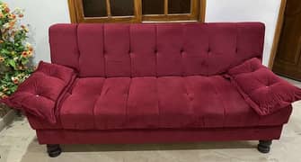 sofa cum bed in maroon colour with new condition only 2 month used