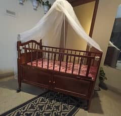 Wooden baby cot with mattress and net frill