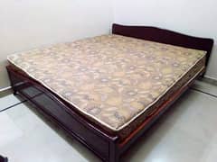 Wooden bed with mattress