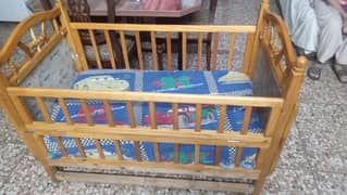 wooden baby cot with mattress inside