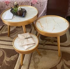 A set of three wooden tables with acrylic top