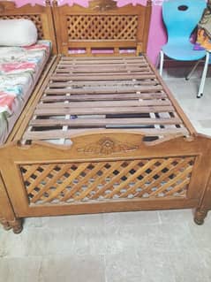 single wooden bed without mattress