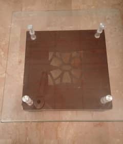 Wooden center table with glass top