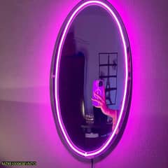 A mirror with pink led lights