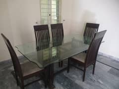 Solid wooden frame Dining table with thick glass top and six chairs