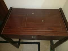A sewing machine wooden table/study table