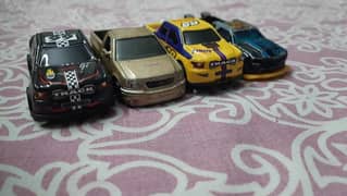 2 hot wheels and 2 normal cars