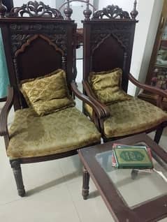 Pair of wooden chairs with table